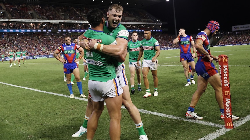 Hudson Young hugs Canberra Raiders teammate Jordan Rapana after a try in their NRL game against the Newcastle Knights.