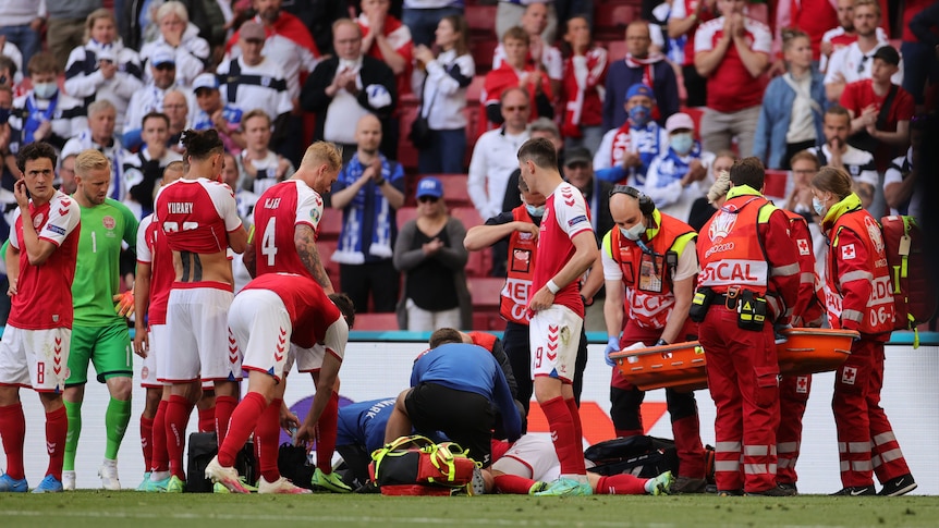 Denmark's Christian Eriksen receives medical attention after collapsing during the match