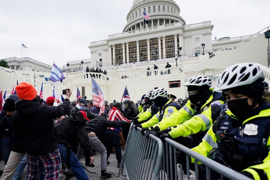 Trump supporters try to break through a police barrier on the US Capitol