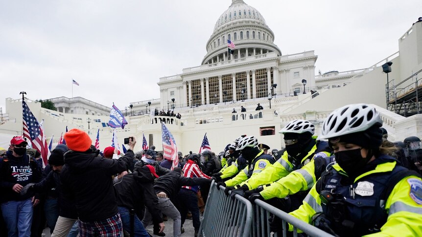 Trump supporters try to break through a police barrier on the US Capitol