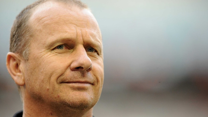 Port Adelaide coach Ken Hinkley watches his team warm up at Docklands against Essendon.