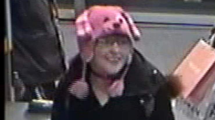 A woman passing through the gates of a train station