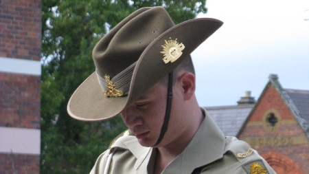 A Launceston soldier pays his respects at the Launceston Cenotaph