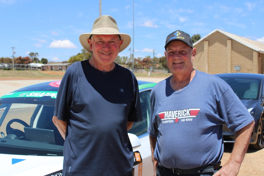 Two men in hats and t-shirts on a sunny day