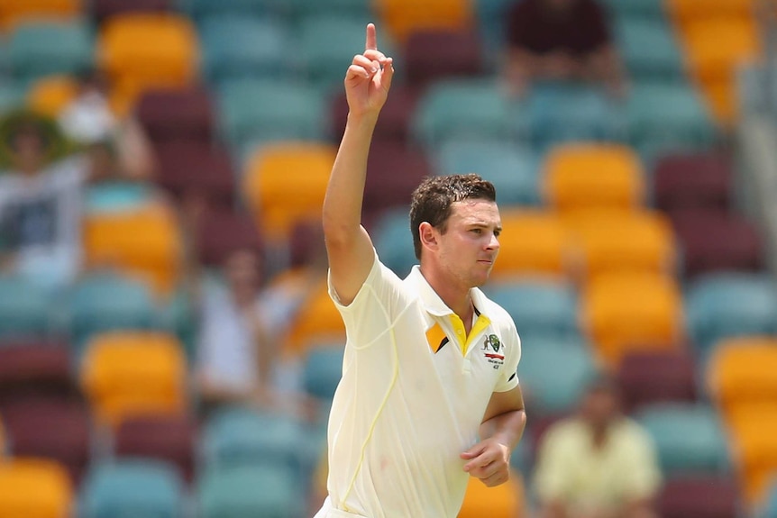 Josh Hazlewood celebrates the wicket of Ravichandran Ashwin on day two of the second Test between Australia and India at the Gabba