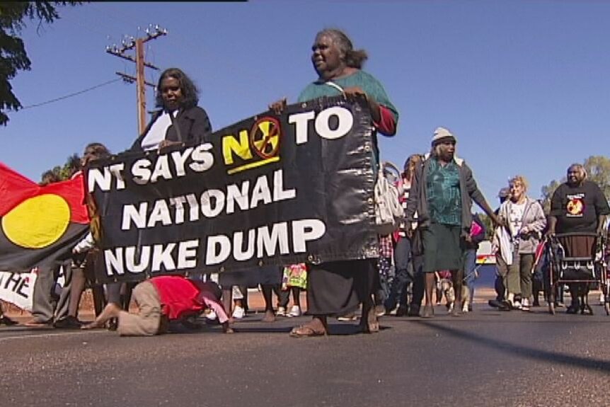Protestors marching with banners against Muckaty.