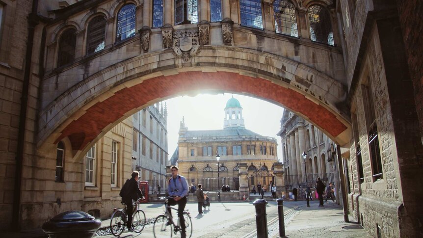 People riding bikes at Oxford University.