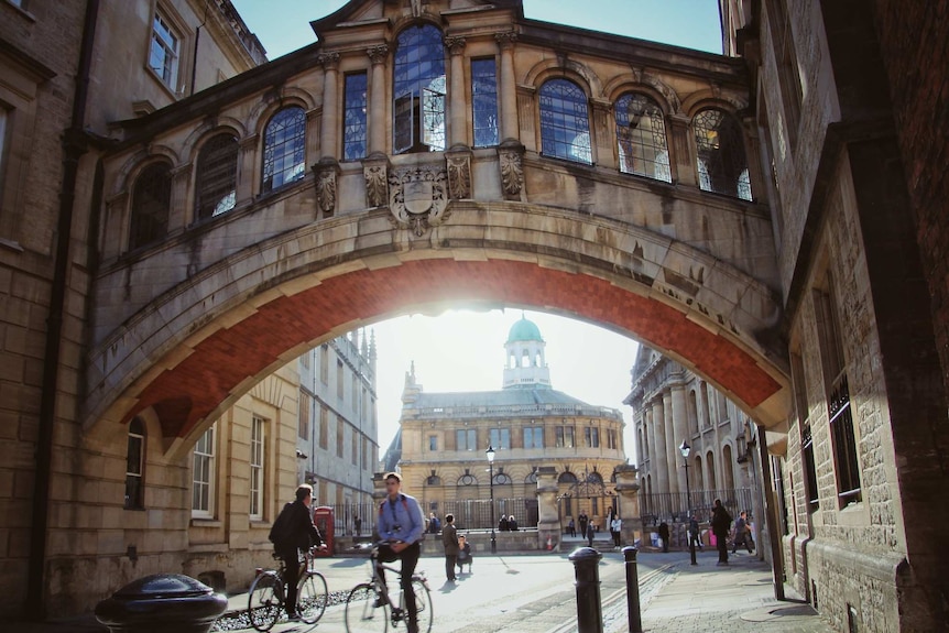 People riding bikes at Oxford University.