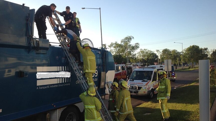 Emergency officers rescue a 30-year-old man from a rubbish truck in Palmerston.