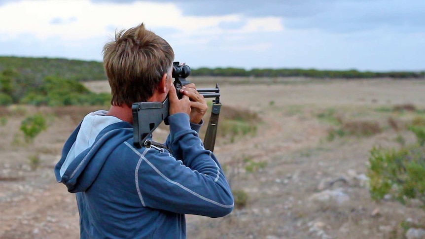 A man shoots a rifle