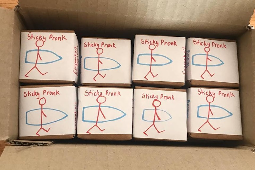A cardboard box full of Sticky Pronk surf wax blocks.