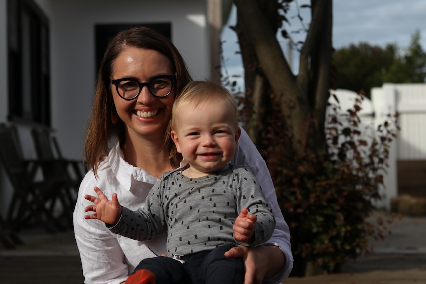 A beautiful mum with her adorable toddler smiling