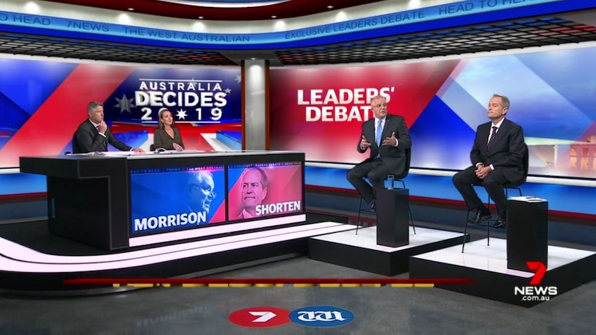A wide shot of the debate, including the hosts and the leaders.