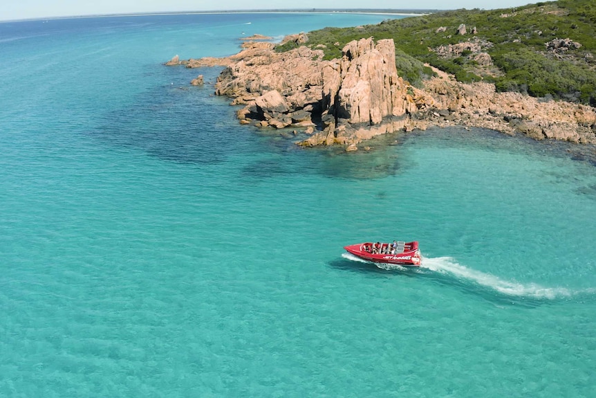 The Jet Adventures jet boat zooming over aqua seas in Dunsborough.