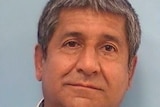 Mugshot of middle aged man with grey hair.