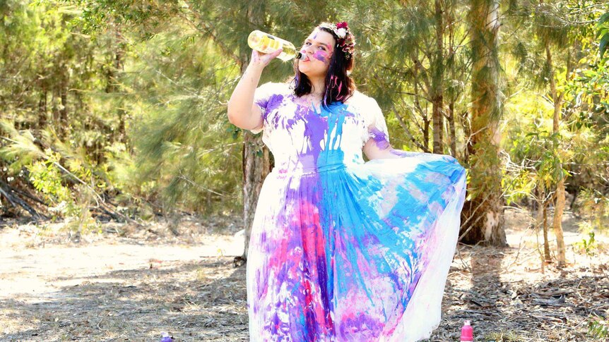 Kira Coleman drinks wine in a wedding dress she trashed