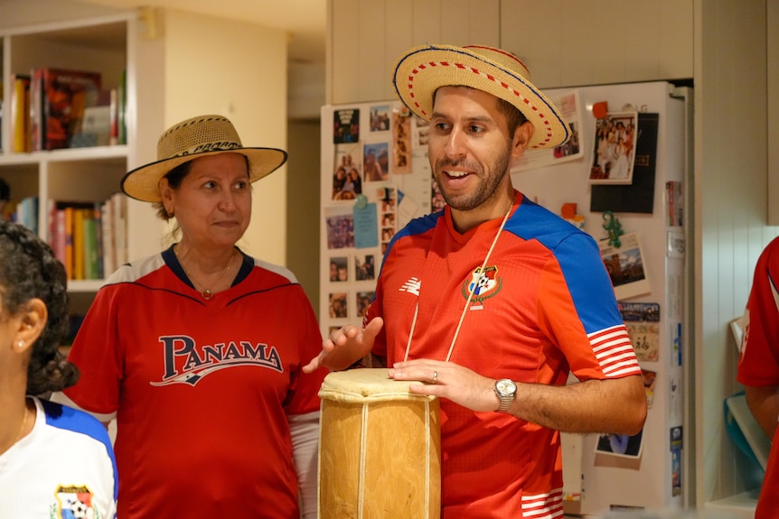 A Panama fan plays a drum.