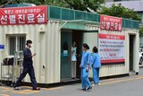 Hospital workers in South Korea stand outside a MERS treatment centre