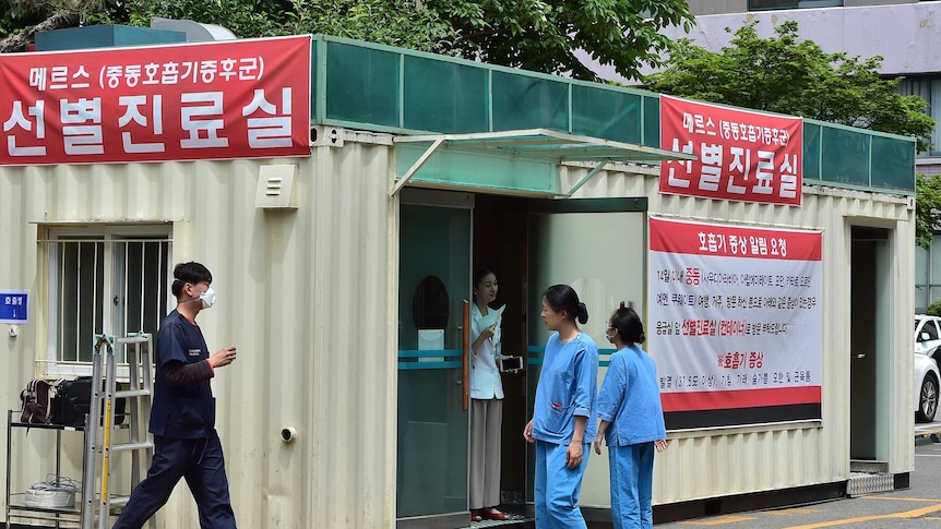 Hospital workers in South Korea stand outside a MERS treatment centre