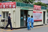 Hospital workers in South Korea stand outside a MERS treatment centre