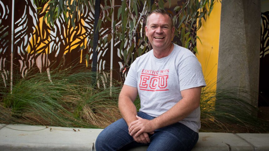 Jason Barrow in the Indigenous support services courtyard in the Ngoolark building