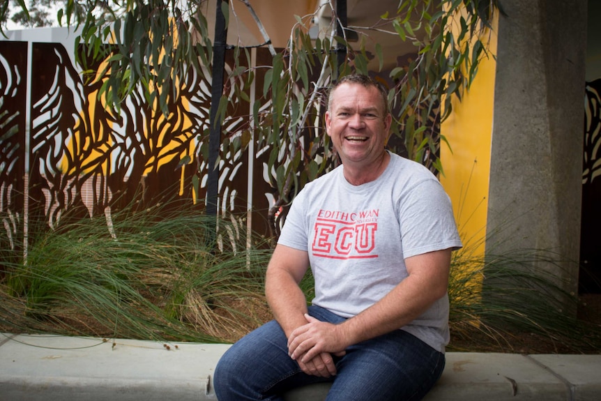Jason Barrow in the Indigenous support services courtyard in the Ngoolark building