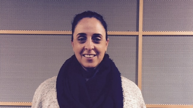 Olympic swimmer Nicole Livingstone stands in front of a grey wall