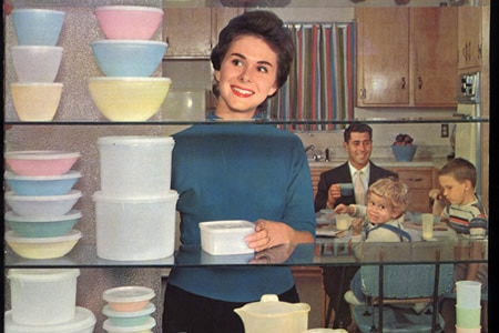 A woman looks at Tupperware in some of the company's marketing material.