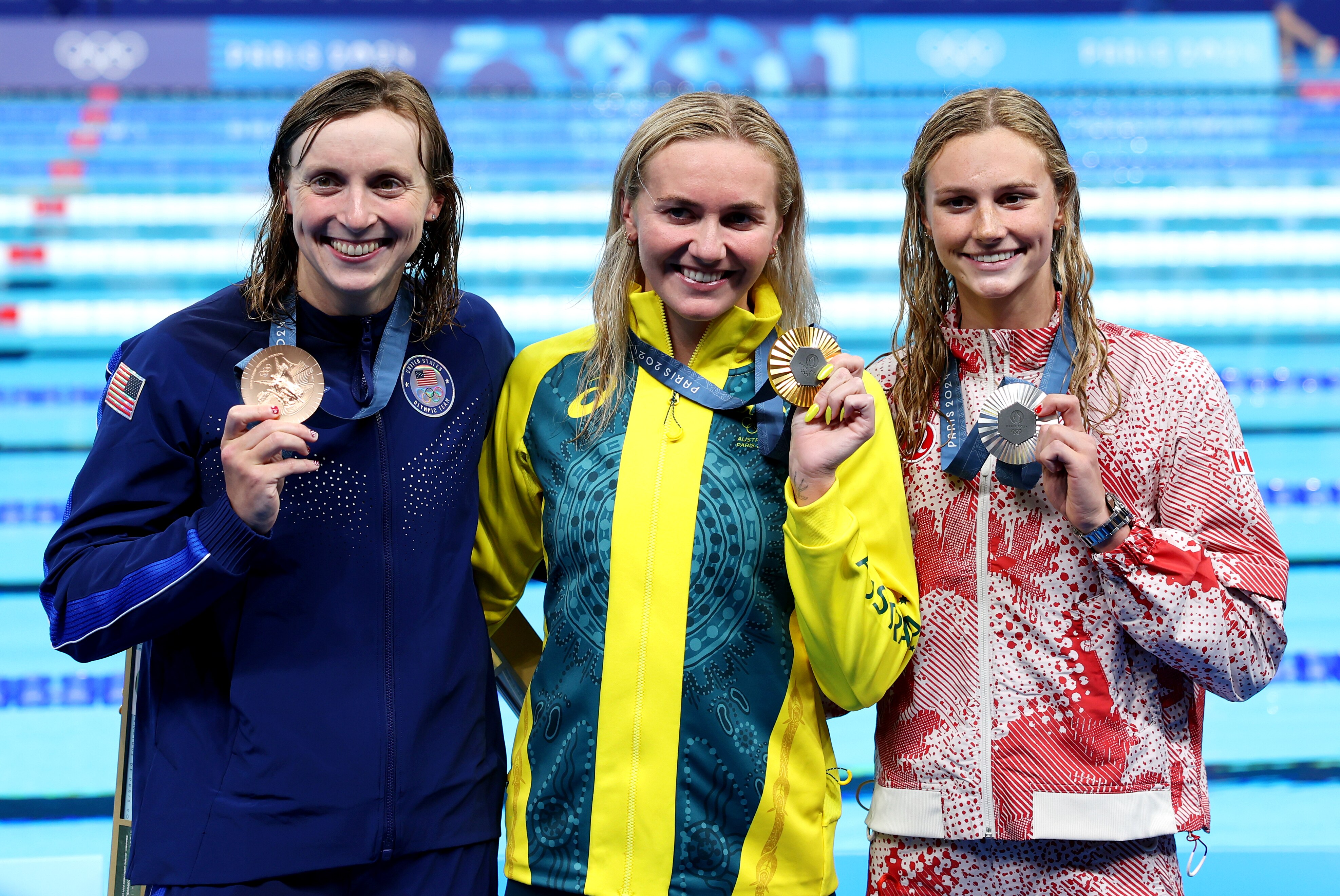 Ariarne Titmus, with Summer McIntosh and Katiee Ledecky show off their medals together at the Paris Olympics.