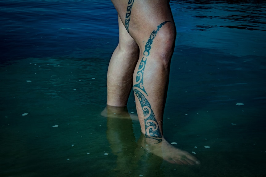 A close up of a leg with a Māori Tā moko tattoo.