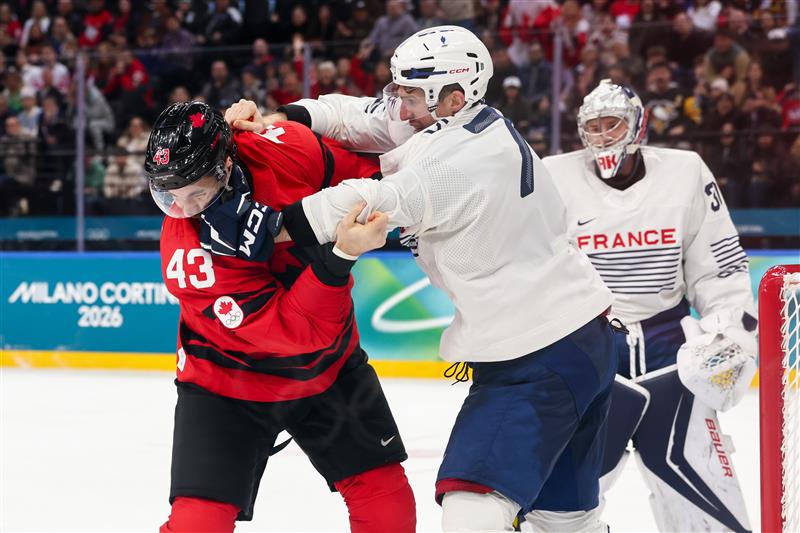 Peirre Crinon punches Tom Wilson during an Olympice ice hockey game.