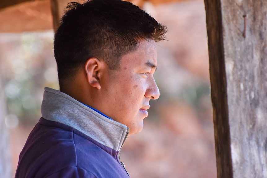 A man in profile looking serious 