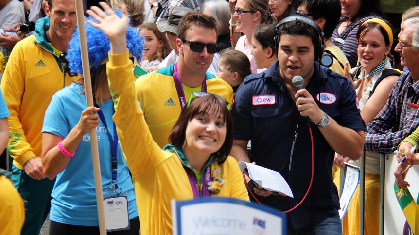 Anna Meares waves to the crowd during the Welcome Home parade for Olympians in Brisbane.