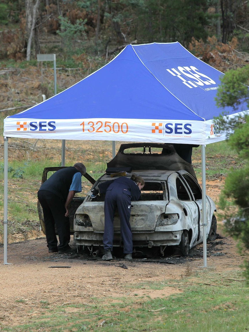 Crime scene officers investigate a burnt-out car found near Wangaratta.