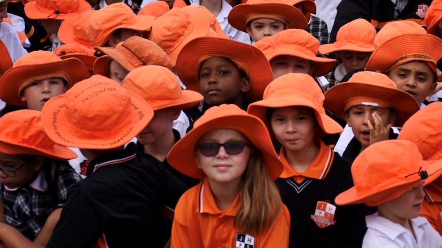 Students sit cross-legged at a school assembly at John Henry Primary School, in Melbourne's south-east.