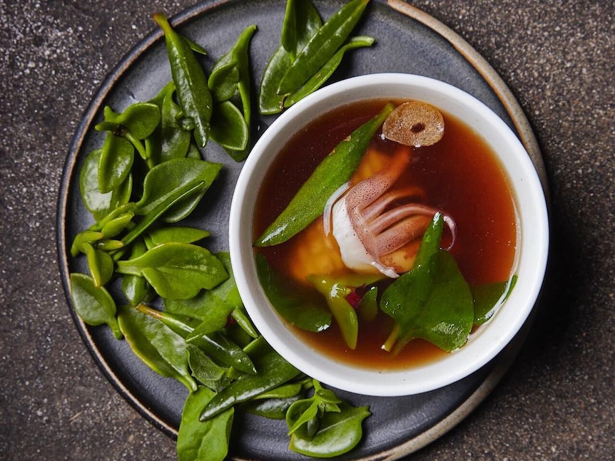 A plate of squid with sea vegetables and warrigal greens.