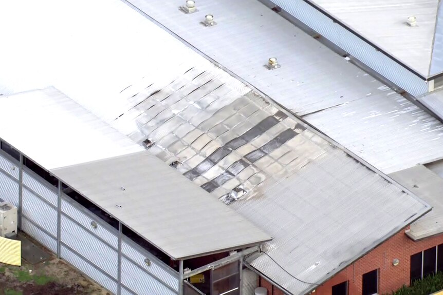 An aerial shot showing the roof of a building damaged by fire at Banksia Hill Juvenile Detention Centre.
