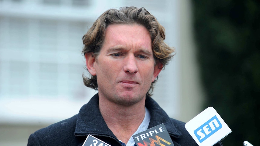 James Hird speaks to media outside his house