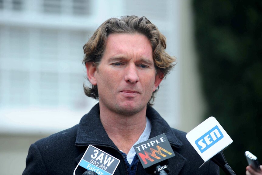 James Hird speaks to media outside his house