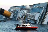 A rescue boat circles the Costa Concordia after the cruise ship ran aground last year.