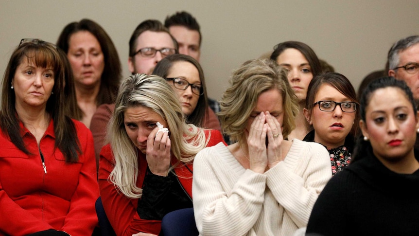 Victims and others look on as Rachael Denhollander speaks at the sentencing hearing for Larry Nassar.