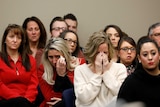 Victims and others look on as Rachael Denhollander speaks at the sentencing hearing for Larry Nassar.