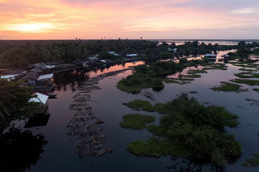 Drone image of hammered rafts that are ready to be transported to Lagos State are seen at sunrise on a river in Ondo, Nigeria