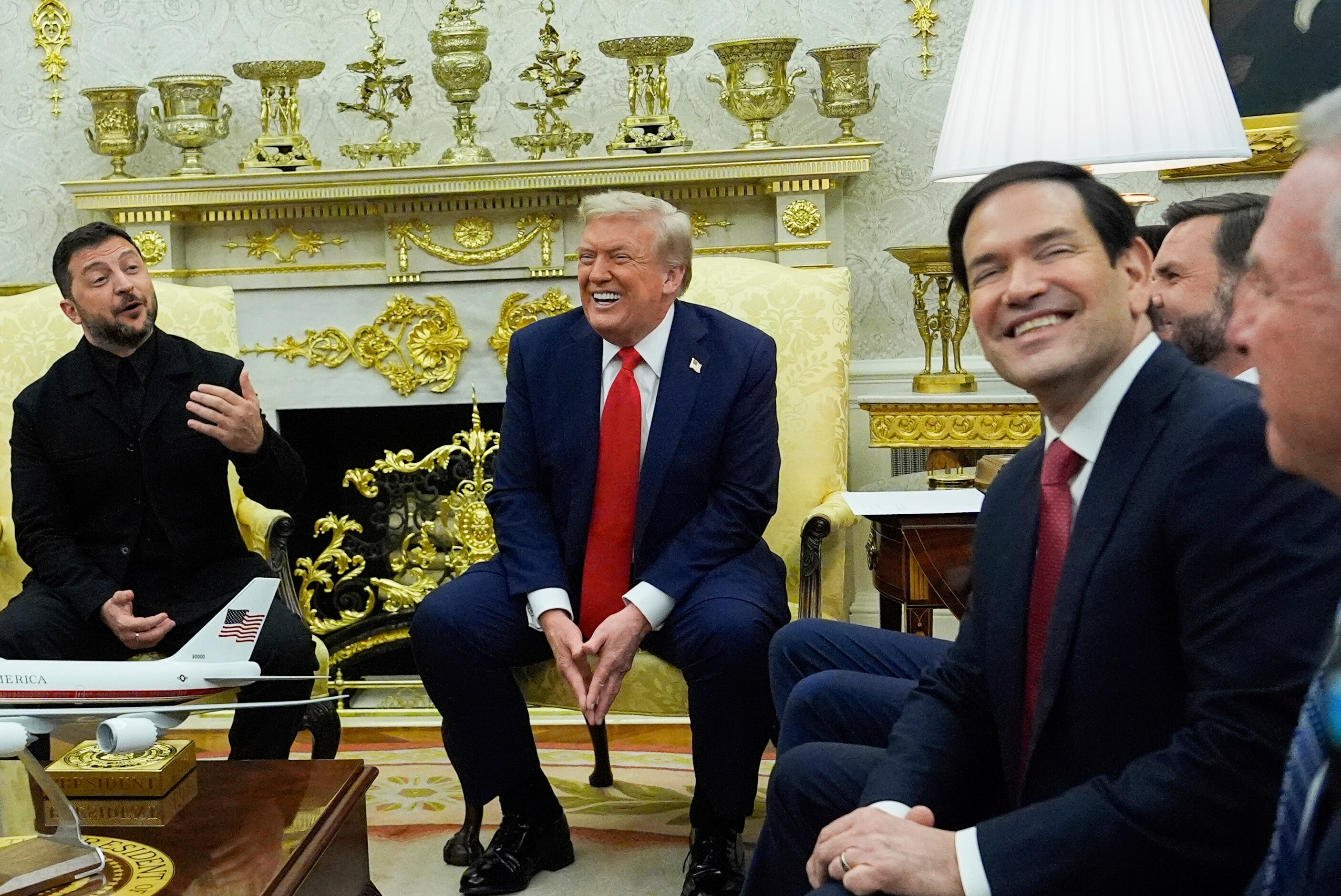 Zelenskyy and Trump in Oval Office smiling with other officials