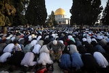 Thousands of Muslims take part in Eid al-Fitr prayers at the Dome of the Rock Mosque. 