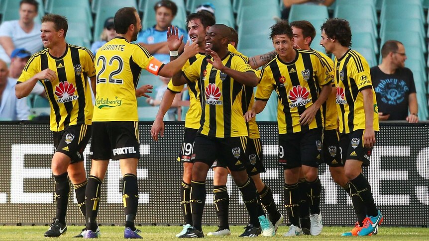 Wellington Phoenix players celebrate a goal by Nathan Burns against Sydney FC.
