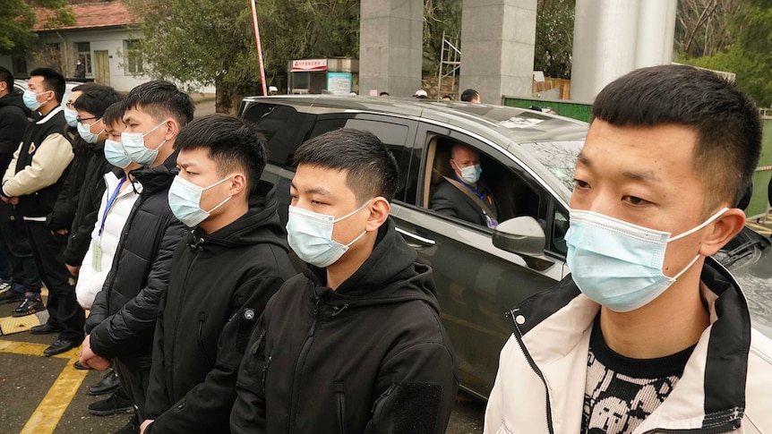 Peter Daszak of the World Health Organization leaves in a car past a row of security personnel at the CDC.