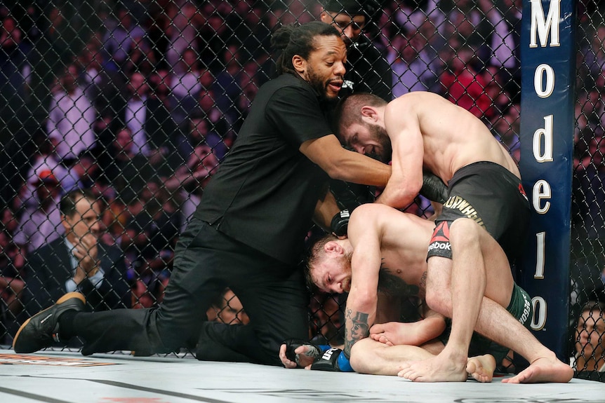 Khabib Nurmagomedov pushed back by referee after defeating Conor McGregor