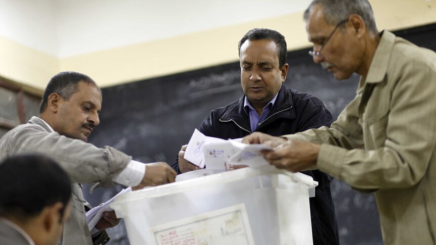 Polling station officials in Cairo count ballots after the first day of voting on a new constitution, December 15, 2012.