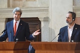 John Kerry (L) speaks during a press conference with Syrian opposition's Ahmed Moaz al-Khatib